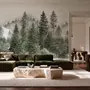 Misty mountain wallpaper mural with tall pine trees, layered green forest and pale foggy ridges