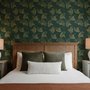 Dark green wallpaper with metallic antique-gold etched ginkgo leaves on a textured forest-green teal ground