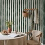 Green striped minimalist wallpaper with vertical deep forest green bands on a soft warm ivory ground.