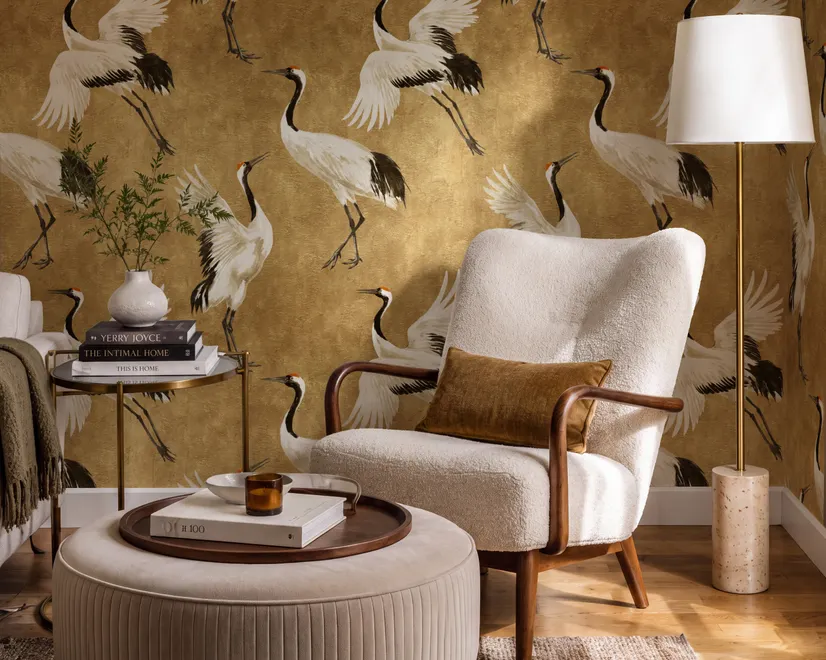 Japanese crane wallpaper with white, black and red cranes in flight on an antique-gold textured ground