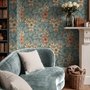 Blue tropical wallpaper with hibiscus, orchids, lilies, monstera leaves and palm fronds on a deep teal-blue ground