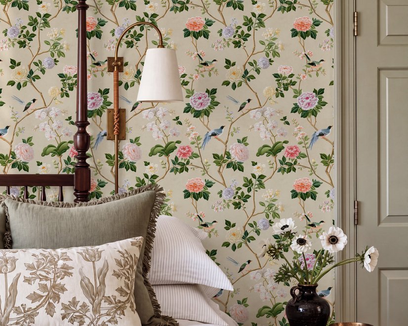 Chinoiserie wallpaper with blue-grey birds, pink peonies, white orchids and green branches on ivory-cream ground