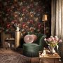 Dark moody floral wallpaper with cream peonies, coral lilies, berries and green foliage on chocolate brown