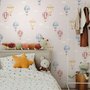 Hot air balloon nursery room wallpaper with watercolour balloons, clouds and stars on a soft blush-pink ground