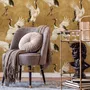 Japanese crane wallpaper with white, black and red cranes in flight on an antique-gold textured ground