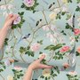 Chinoiserie wallpaper with peach birds, orchids and peonies on a pale duck egg blue ground