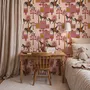 Tropical foliage wallpaper with black panthers, pink palace facades and ochre palms on pale peach