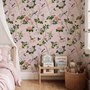 Cute pink wallpaper with birds, tan branches, green leaves and ivory, coral and lilac flowers.