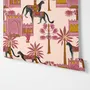 Tropical foliage wallpaper with black panthers, pink palace facades and ochre palms on pale peach