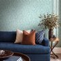 Aqua fern wallpaper with overlapping icy blue palm fronds on a pale aqua ground