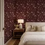 Pink butterflies wallpaper on a claret ground with cream flowers, moons, stars and spotted mushrooms.