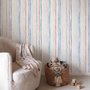 Blue and light blue wallpaper with hand-painted vertical watercolour stripes on a clean white ground
