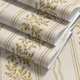Gold and white wallpaper with antique gold leafy sprig stripes on parchment cream