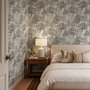 Monochrome wallpaper with grey tree toile on a clean white ground