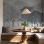 Light gray wallpaper mural with misty forest trees, falling leaves and birds