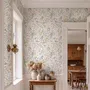 Watercolour wildflower wallpaper with pastel flowers and sage leaves on a white ground