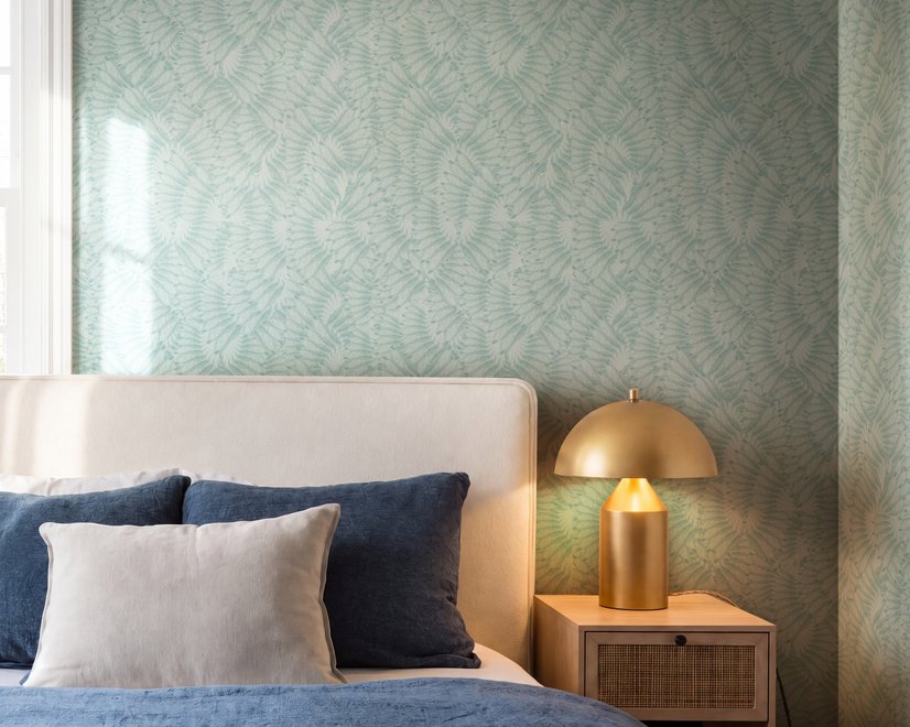 Aqua fern wallpaper with overlapping icy blue palm fronds on a pale aqua ground