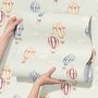 Watercolor blue wallpaper with hot air balloons, cream clouds and peach stars on pale sage green