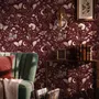 Pink butterflies wallpaper on a claret ground with cream flowers, moons, stars and spotted mushrooms.