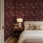 Pink butterflies wallpaper on a claret ground with cream flowers, moons, stars and spotted mushrooms.