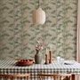 Vintage bamboo wallpaper with sage and smoky blue-green leaves on a warm taupe ground