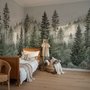 Misty mountain wallpaper mural with tall pine trees, layered green forest and pale foggy ridges