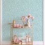 Aqua fern wallpaper with overlapping icy blue palm fronds on a pale aqua ground