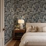 Navy wallpaper with warm ivory and taupe grey toile tree repeat on deep slate blue ground
