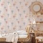 Hot air balloon nursery room wallpaper with watercolour balloons, clouds and stars on a soft blush-pink ground