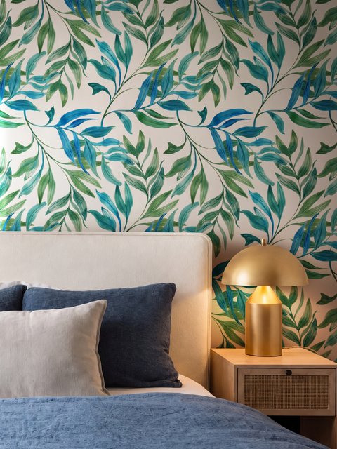 Dark olive green wallpaper with teal and cobalt watercolour lance leaves on a white ground