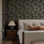 Black wallpaper with antique metallic gold ginkgo leaves on a mottled charcoal ground