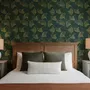Dark green wallpaper with metallic antique-gold etched ginkgo leaves on a textured forest-green teal ground