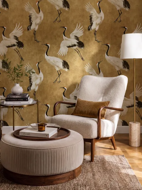 Japanese crane wallpaper with white, black and red cranes in flight on an antique-gold textured ground