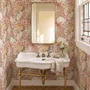 Pink tropical wallpaper with ivory fan palms, orchids, coral blossoms and sage foliage on dusty rose