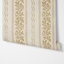 Gold and white wallpaper with antique gold leafy sprig stripes on parchment cream