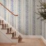 Blue wallpaper with indigo botanical stripework, pinstripes and dotted borders on warm cream parchment