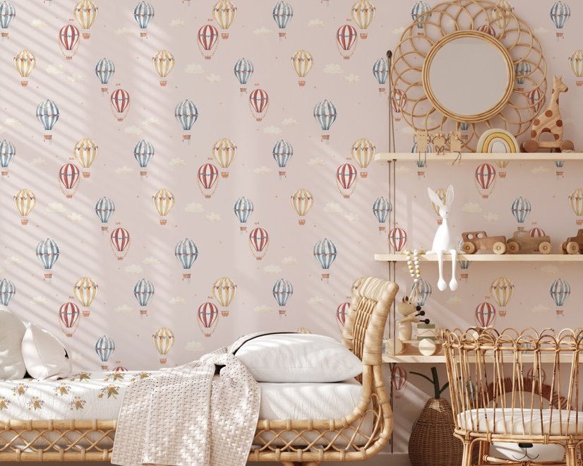 Hot air balloon nursery room wallpaper with watercolour balloons, clouds and stars on a soft blush-pink ground