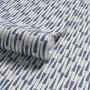 Cream colored wallpaper with denim blue geometric totem stripe repeat on a linen texture ground