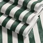 Green striped minimalist wallpaper with vertical deep forest green bands on a soft warm ivory ground.