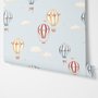 Hot air balloon wallpaper with watercolor balloons, ivory clouds and peach gold stars on pale powder blue