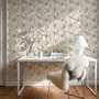 Pink wallpaper with watercolour blush, coral and yellow wildflowers, sage leaves and stems on a warm cream-white ground.