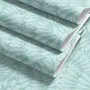 Aqua fern wallpaper with overlapping icy blue palm fronds on a pale aqua ground