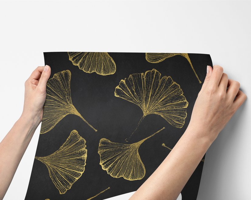 Black wallpaper with antique metallic gold ginkgo leaves on a mottled charcoal ground