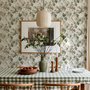 Vintage nature wallpaper with pale monkeys, sage grape leaves, white grape clusters and taupe vines on ivory.