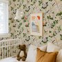 Chinoiserie wallpaper with blue-grey birds, pink peonies, white orchids and green branches on ivory-cream ground