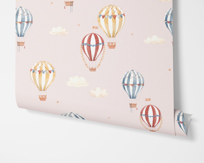 Hot air balloon nursery room wallpaper with watercolour balloons, clouds and stars on a soft blush-pink ground