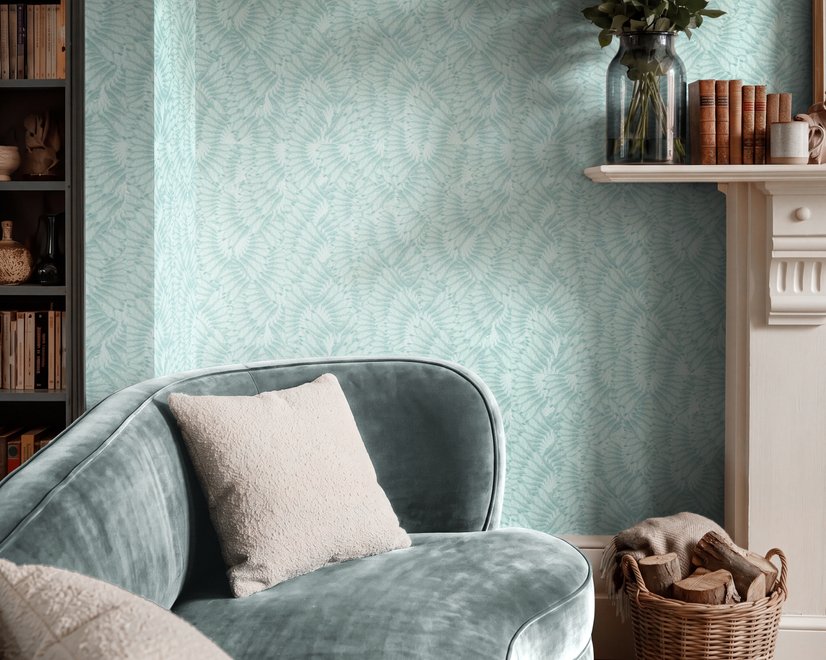 Aqua fern wallpaper with overlapping icy blue palm fronds on a pale aqua ground