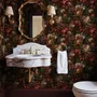 Dark moody floral wallpaper with cream peonies, coral lilies, berries and green foliage on chocolate brown