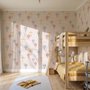 Hot air balloon nursery room wallpaper with watercolour balloons, clouds and stars on a soft blush-pink ground