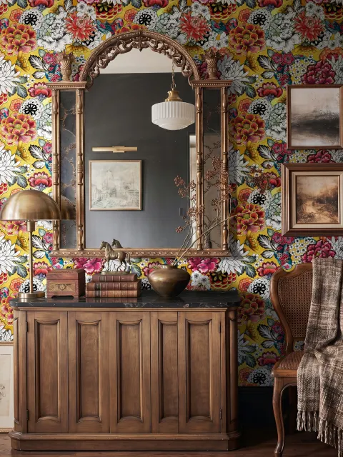 Floral and fish wallpaper with coral blooms, teal fish and black white flowers on metallic mustard-gold ground